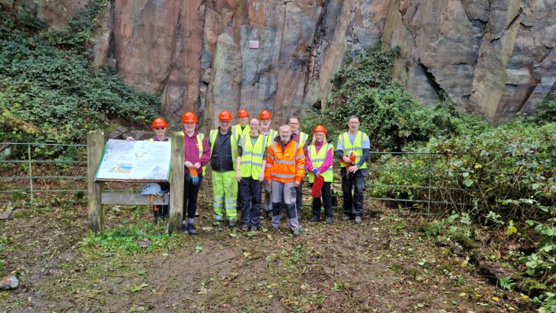 Geoconservation volunteers at Morley Quarry standing in front of a rock face.
